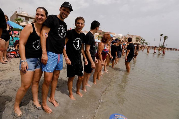 Archivo - Una hilera de personas participa en una cadena humana por la recuperación del Mar Menor, en la Playa en Los Alcázares, a 13 de agosto de 2022, en Los Alcázares, Murcia (España)