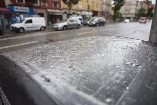 Gotas de lluvia sobre el capó de un coche.