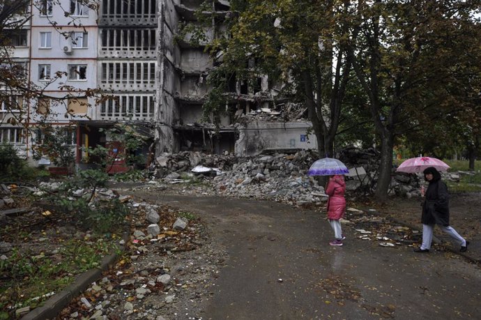 September 20, 2022, Kharkiv, Ukraine: People walk near a residential building damaged by shelling by the Russian army in Saltivka, a northern district of Kharkiv. Russia invaded Ukraine on 24 February 2022, triggering the largest military attack in Euro