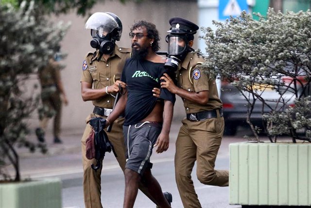 Agentes de policía detienen a un manifestante antigubernamental durante una protesta en la que se condenaba la ley de prevención del terrorismo