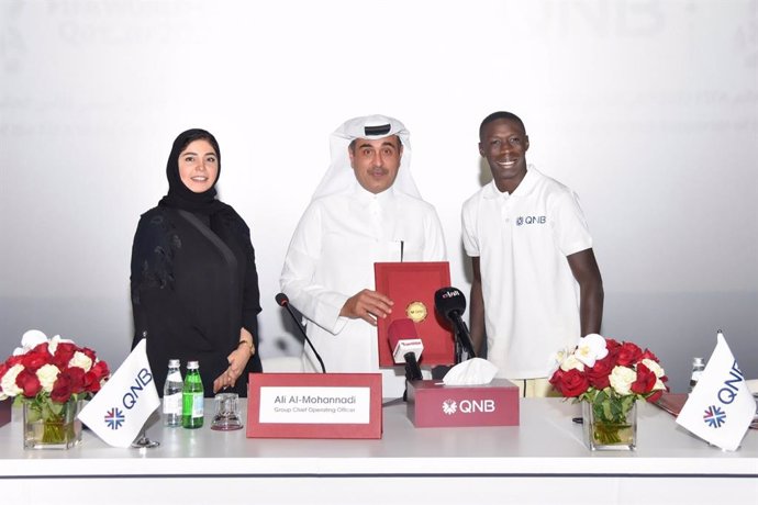 Internet sensation Khabane "Khaby" Lame, the worlds most followed person on TikTok, is pictured at the official signing ceremony with Ali Rashid Al-Mohannadi, QNB Group Executive General Manager & Group Chief Operating Officer, and Heba Ali Al-Tamimi, 