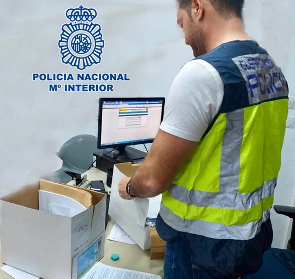 Archivo - Un agente de la Policía Nacional investiga documentación, en una imagen de archivo.