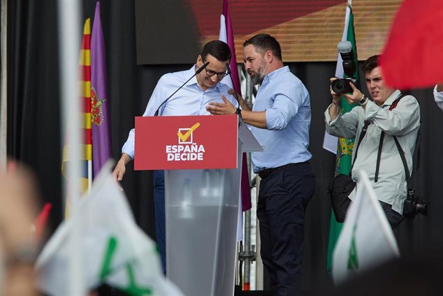 El líder nacional de Vox, Santiago Abascal, conversa con el primer ministro de Polonia, Mateusz Morawiecki (i), que participa en el evento 'Viva 22'  a 9 de octubre de 2022, en Madrid (España). 