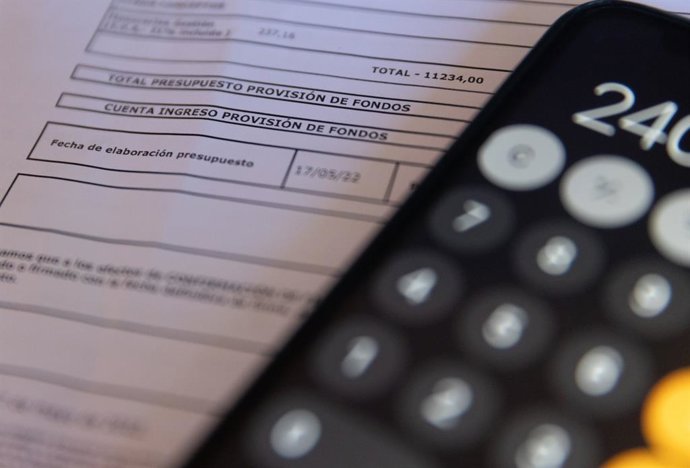 Archivo - Una calculadora y una escritura de compraventa de una hipoteca, a 2 de junio de 2022, en Madrid (España).