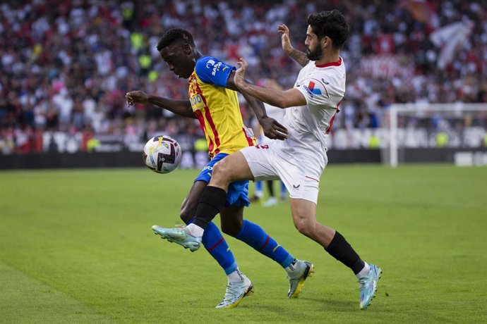 18 October 2022, Spain, Seville: Valencia's Ilaix Moriba (R) and Sevilla's Isco battle for the ball during the Spanish Primera Division soccer match between Sevilla CF and Valencia CF at Ramon Sanchez Pizjuan. Photo: Jose Luis Contreras/DAX via ZUMA Pre