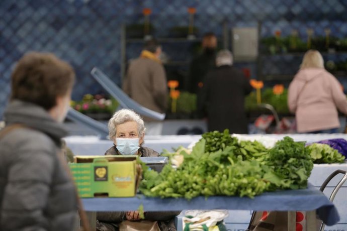 Archivo - Una mujer en un puesto local de verduras y productos del campo, en el mercado tradicional de la Plaza de Abastos de Lugo, a 22 de marzo de 2022, en Lugo, Galicia (España). El paro convocado a nivel nacional por la Plataforma para la Defensa de