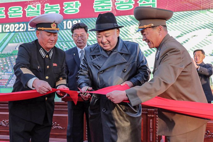 HANDOUT - 10 October 2022, North Korea, Hamju County: An undated picture provided by the North Korean state news agency (KCNA) on 11 October 2022 shows North Korean leader Kim Jong-un (2nd R) cutting a red ribbon during a ceremony to mark the completion