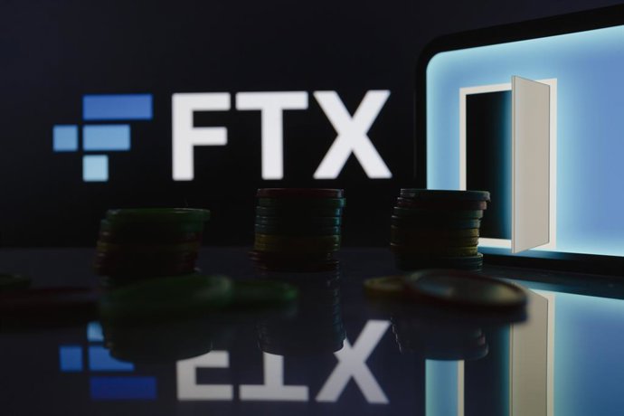 November 12, 2022, Asuncion, Paraguay: FTX logo displayed behind coins and visual representation of open door. ''Following the Chapter 11 bankruptcy filings - FTX U.S. and FTX.com initiated precautionary steps to move all digital assets to cold storage.