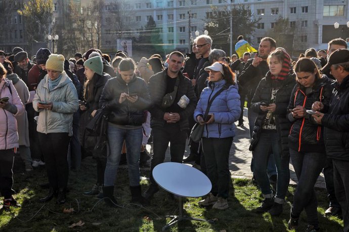 November 14, 2022, Kherson, Ukraine: Local residents try to connect to the Internet and make phone calls outside the Kherson Regional State Administration building in Kherson which was liberated from Russian invaders Friday, November 11, southern Ukrain