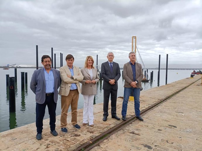 La presidenta del Puerto de Huelva, Pilar Mirnada, ya los representantes de Marina del Odiel junto a las obras de la infraestructura.