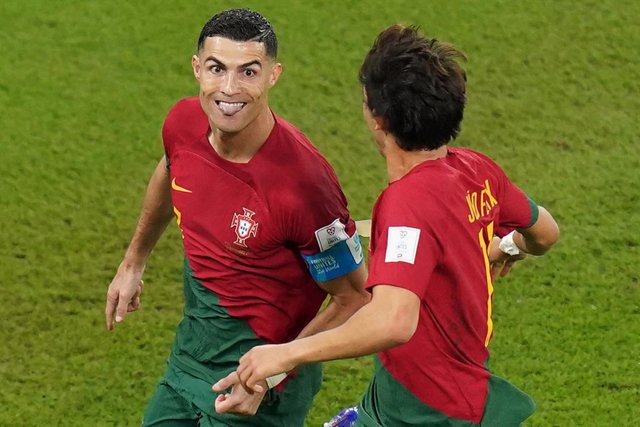 24 November 2022, Qatar, Doha: Portugal's Cristiano Ronaldo (L) celebrates scoring his side's first goal from the penalty spot during the FIFA World Cup Qatar 2022 Group H soccer match between Portugal and Ghana at Stadium 974. Photo: Adam Davy/PA Wire/
