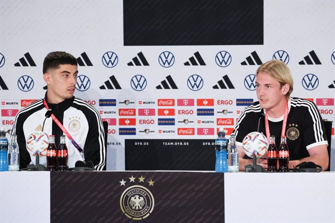 25 November 2022, Qatar, Al-Shamal: Germany's Kai Havertz (L) and Julian Brandt speak during a press conference for the German national soccer team at the German Football Federation (DFB) media center, during the 2022 FIFA Qatar World Cup. Photo: Christ