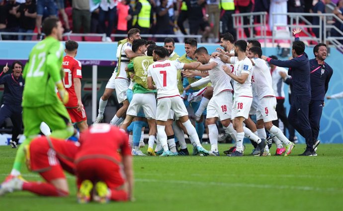 25 November 2022, Qatar, Ar-Rayyan: Iran's Roozbeh Cheshmi celebrates scoring their side's first goal of the game during the FIFA World Cup Qatar 2022 Group B soccer match between Wales and Iran at Ahmad bin Ali Stadium. Photo: Martin Rickett/PA Wire/dpa