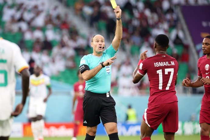 Referee Antonio Mateu Lahoz of Spain gives a yellow card to Ismaeel Mohamad of Qatar during the FIFA World Cup 2022, Group A football match between Qatar and Senegal on November 25, 2022 at Al Thumama Stadium in Doha, Qatar - Photo Jean Catuffe / DPPI