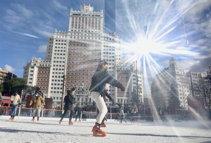 Archivo - Varias personas patinan en la pista de hielo del mercadillo La Navideña, situado en la plaza de España, a 5 de enero de 2022, en Madrid (España).