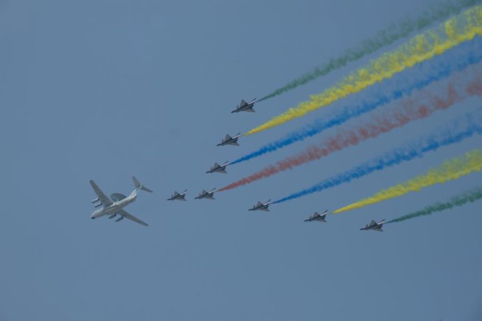 Archivo - 01 October 2019, China, Beijing: A formation of military airplanes with colorful 'tail' fly over Tian'anmen Square and downtown during a military parade as pert of the celebration ceremony of the 70th anniversary of People's Republic of China'