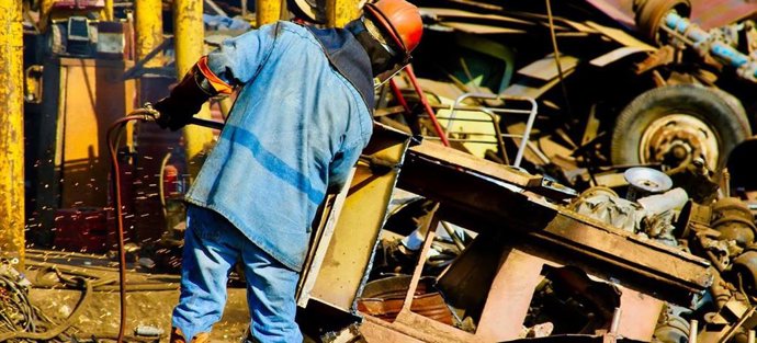 Archivo - Un trabajador en un desguace de coches en México.