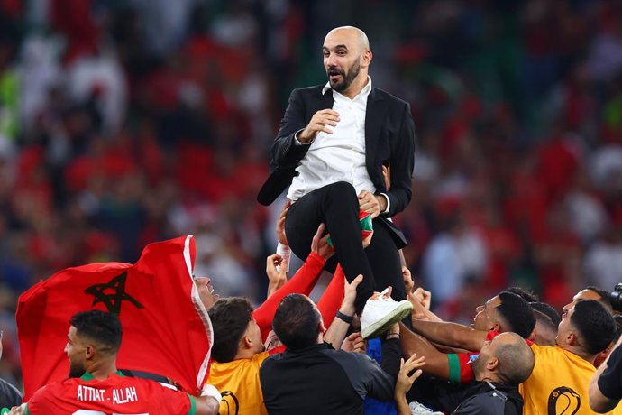 10 December 2022, Qatar, Doha: Morocco's coach Walid Regragui is thrown in the air by his players as they celebrate victory in the FIFA World Cup Qatar 2022 Quarter-Final soccer match between Morocco and Portugal at Al-Thumama stadium. Photo: Tom Weller