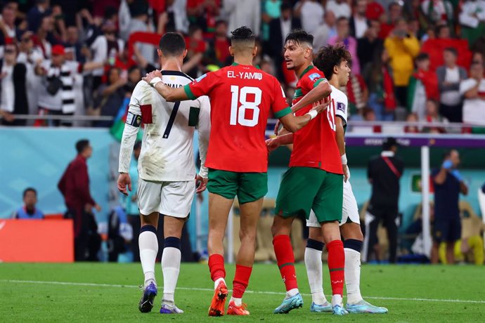 10 December 2022, Qatar, Doha: Portugal's Cristiano Ronaldo is consoled by Morocco's Jawad El Yamiq after the FIFA World Cup Qatar 2022 Quarter-Final soccer match between Morocco and Portugal at Al-Thumama stadium. Photo: Tom Weller/dpa
