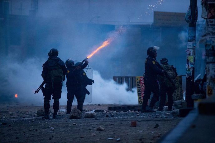 12 December 2022, Peru, Arequipa: A police officer fires tear gas towards demonstrators during a protest. Photo: Denis Mayhua/dpa