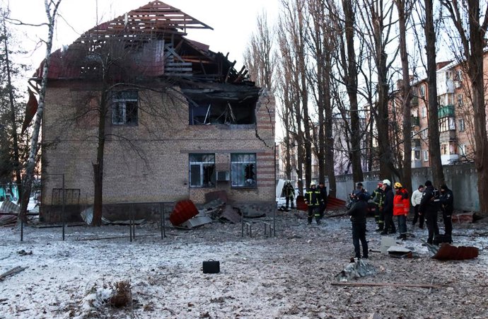 14 December 2022, Ukraine, Kiev: Rescuers and law enforcers stand near a building damaged by the falling fragments of a kamikaze drone at Kiev's Shevchenkivskyi district after a Russian drone attack. Photo: -/Ukrinform/dpa
