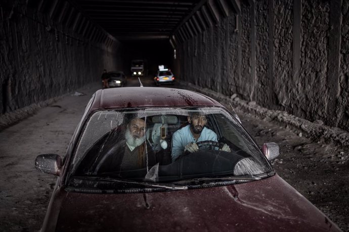 Archivo - 13 November 2022, Afghanistan, Salang Pass: Two Afghan men drive their car through the Salang Tunnel while crossing the Hindu Kush on the Salang Pass, the primary mountain pass connecting northern Afghanistan with Parwan Province, with onward 