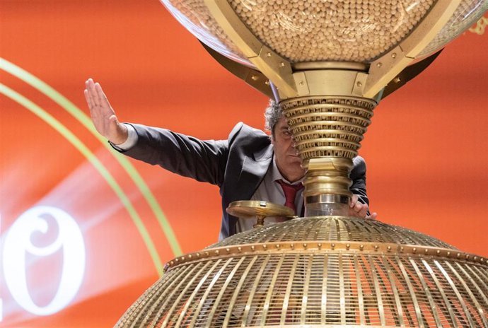 Un hombre prepara los bombos para dar comienzo al Sorteo Extraordinario de la Lotería de Navidad 2022, en el Teatro Real de Madrid.