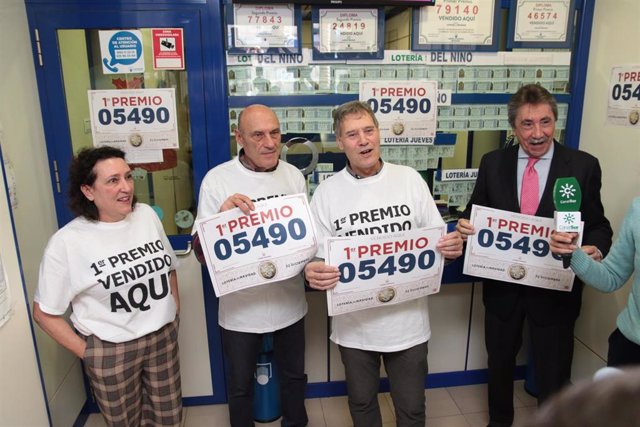 Los responsables de la administración lotería 2 de Roquetas de Mar, celebran junto al delegado de loterías (d), que ha vendido el Gordo del sorteo la Lotería de Navidad, correspondiente al número 05490. 