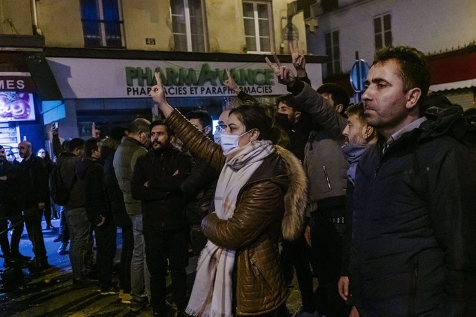 23 December 2022, France, Paris: Members of the Kurdish community gather on the street following brief clashes with the police after three people were killed when shots were fired at a Kurdish community centre in central Paris in what could possibly be 