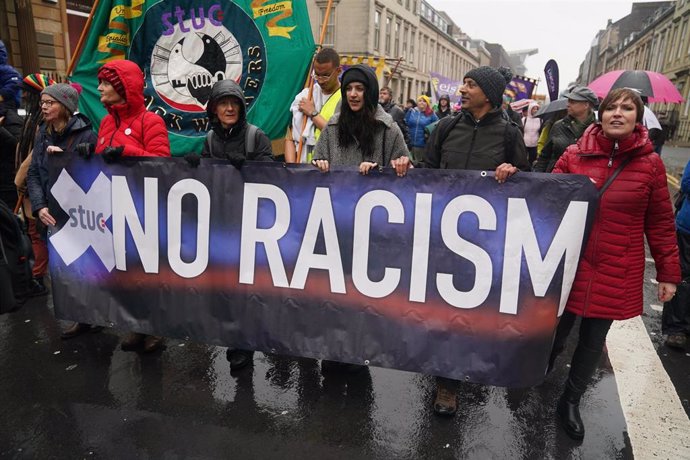 26 November 2022, United Kingdom, Glasgow: People take part in an anti-racism and anti-fascist march in Glasgow, organised by the Scottish Trade Unions Congress (STUC), as part of the annual St Andrew's Day march and rally.