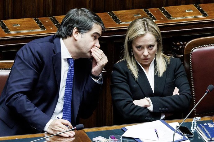 13 December 2022, Italy, Rome: Italian Minister of European Affairs Raffaele Fitto (L) talks to Italian Prime Minister Giorgia Meloni during a session at the Chamber of deputies. Photo: Roberto Monaldo/LaPresse via ZUMA Press/dpa
