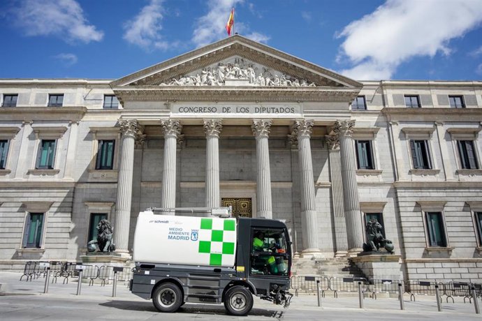 Archivo - Un vehículo de limpieza pasa por delante del Congreso de los Diputados 