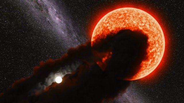 Una representación artística de la estrella Gaia 17 Bpp parcialmente eclipsada por la nube de polvo que rodea a una estrella compañera más pequeña.