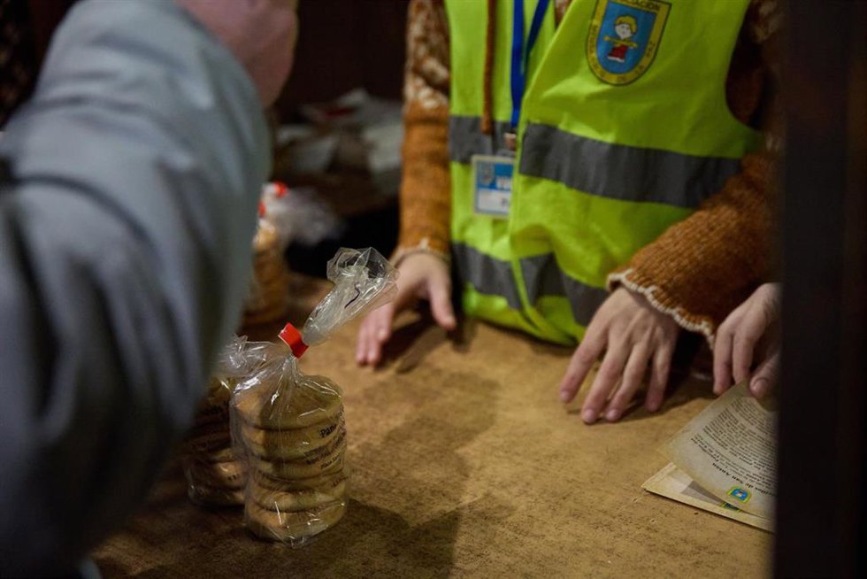 Venta de los tradicionales panecillos de San Antón que ha comprado en la Iglesia de San Antón