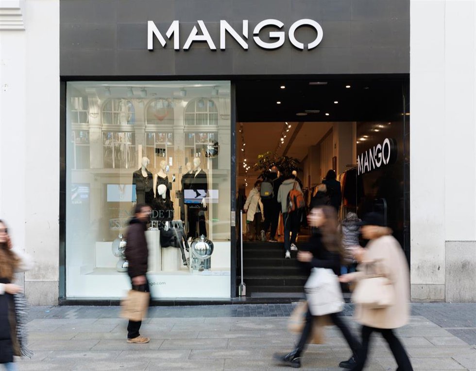 Varias personas caminan frente a una tienda de Mango en Madrid (España).