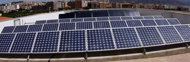 Imagen de placas solares en la parte superior de un edificio.