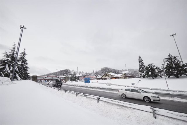 Varios coches circulan durante la nevada.