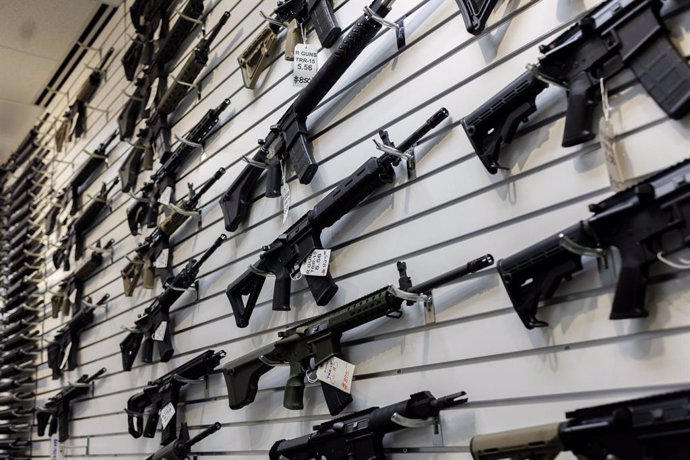 January 16, 2023: A selection of AR-15-style rifles hangs on a wall at R-Guns store on Jan. 11, 2023, in Carpentersville, Illinois, a day after the state ban.