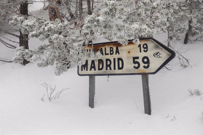 Un cartel indica la distancia a Madrid en la carretera de acceso al Puerto de Navacerrada, a 19 de enero de 2023