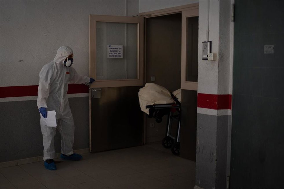 Archivo - Varios operarios protegidos de los Servicios Funerarios trasladan un cuerpo de una residencia  durante la pandemia.