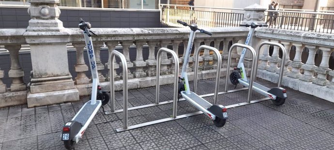 Patinetes eléctricos aparcados en un aparcabicis en Bilbao.