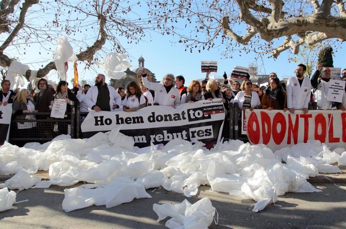 Manifestantes protestan con pancartas y batas blancas durante una manifestación de Metges de Catalunya, el segundo día de huelga, a 26 de enero de 2023, en Barcelona