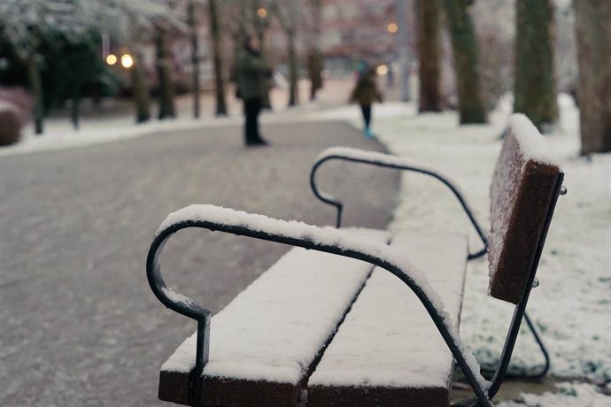 Un banco con  una capa de nieve en un parque de Vitoria, a 18 de enero de 2023, en Vitoria-Gasteiz 