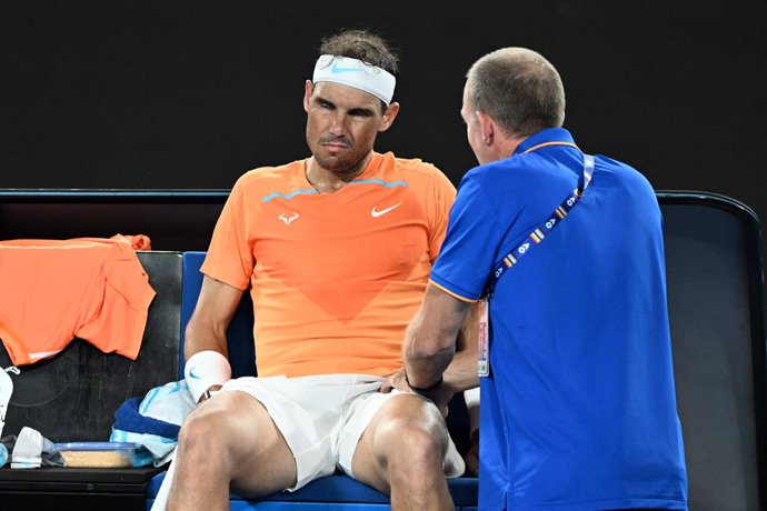 Rafael Nadal of Spain receives medical treatment during his match against Mackenzie McDonald of the USA during the 2023 Australian Open tennis tournament at Melbourne Park in Melbourne, Wednesday, January 18, 2023. (AAP Image/Diego Fedele) NO ARCHIVING,