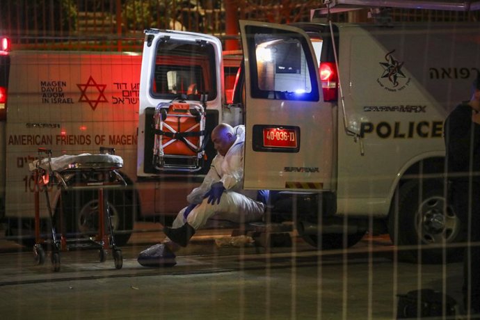 27 January 2023, Israel, Jerusalem: An Israeli emergency service personal rests in a Hospital vehicle at the site of a shooting attack near a synagogue. Eight people were killed in the shooting in an Israeli settlement in East Jerusalem on Friday, polic