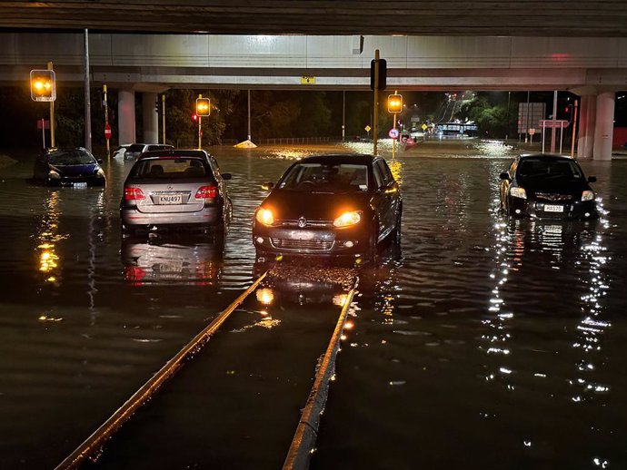 AUKLAND, Jan. 27, 2023  -- Vehicles drive on a flooded street in Auckland, New Zealand, Jan. 27, 2023. A state of emergency was declared in Auckland on Friday as heavy rains caused widespread flooding in New Zealand's biggest city.