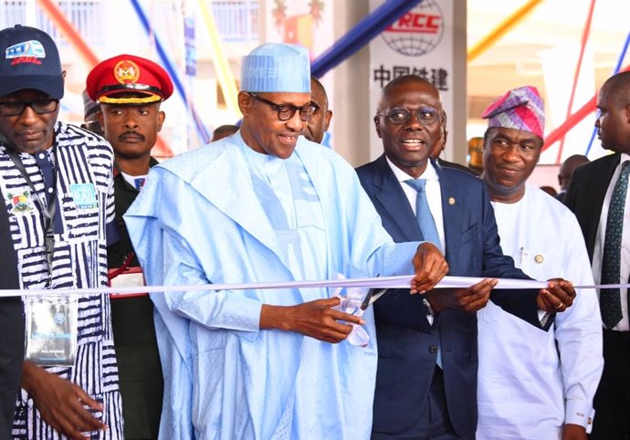 LAGOS, Jan. 25, 2023  -- Nigerian President Muhammadu Buhari cuts the ribbon at the inauguration ceremony of the first phase of a China-built electric-powered light rail project in Lagos, Nigeria, Jan. 24, 2023. The first phase of the project in Nigeria