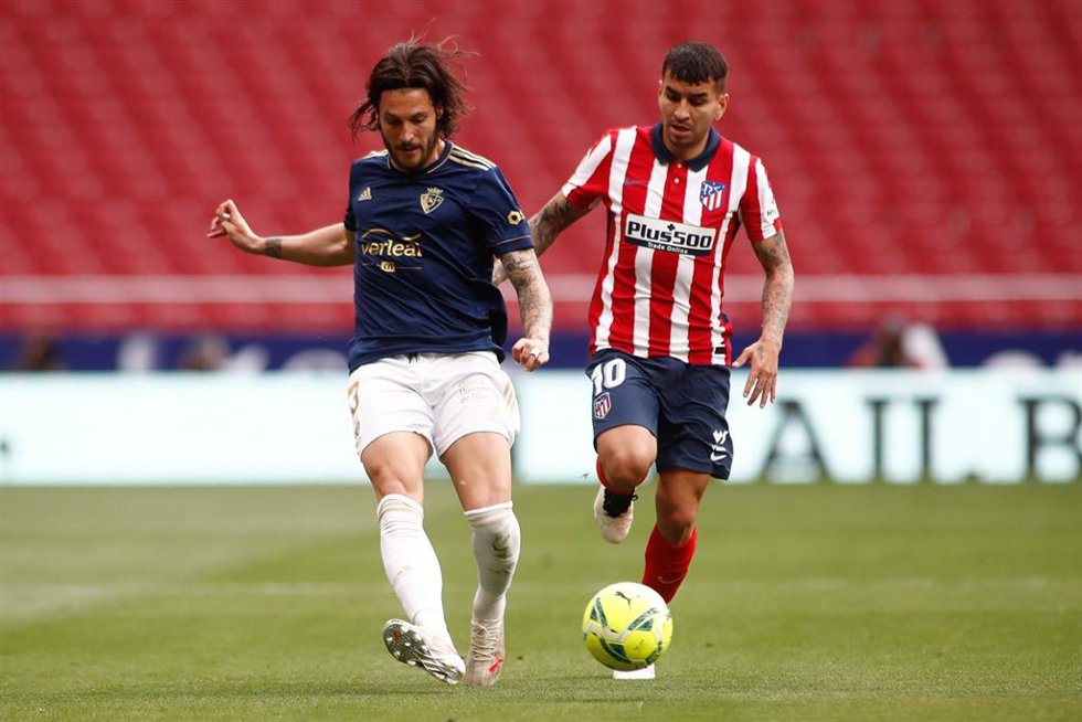 Archivo - El lateral de Osasuna Juán Cruz golpea el balón ante el delantero del Atlético de Madrid Ángel Correa, en el Cívitas Metropolitano. 