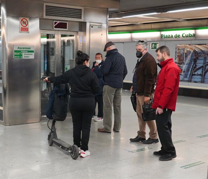Usuaria con patinete en el Metro de Sevilla.