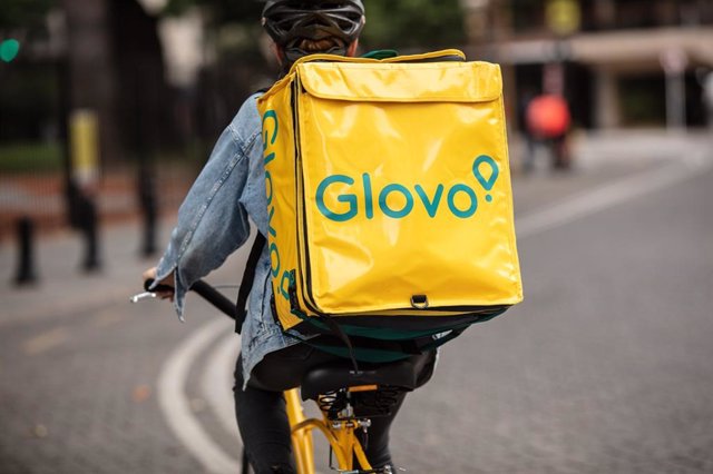 Un repartidor de Glovo en bicicleta por una calle del centro de Madrid